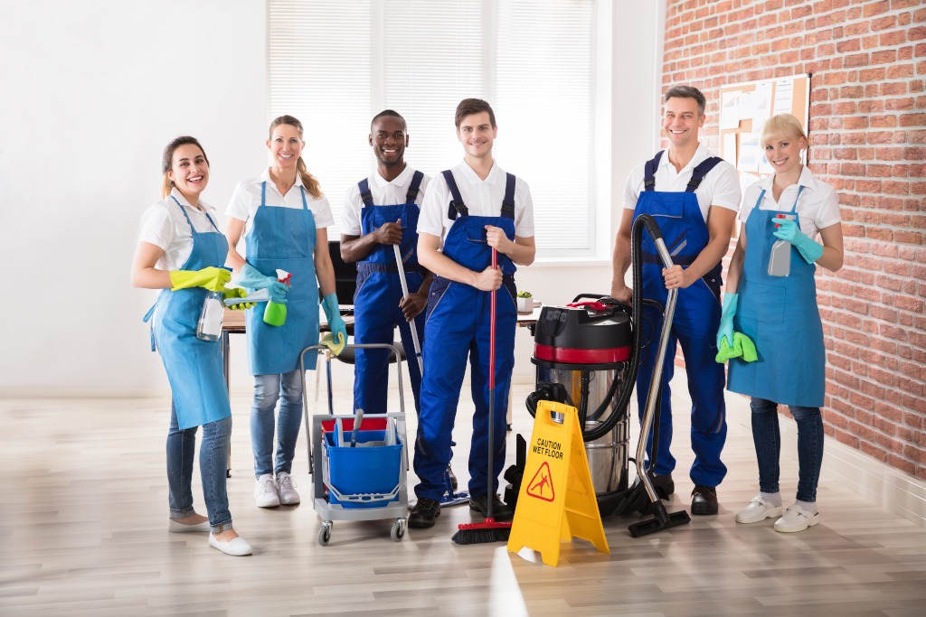 The cleaning team posing together with their equipment
